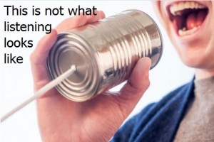 A person yelling into a tin can with a string attached